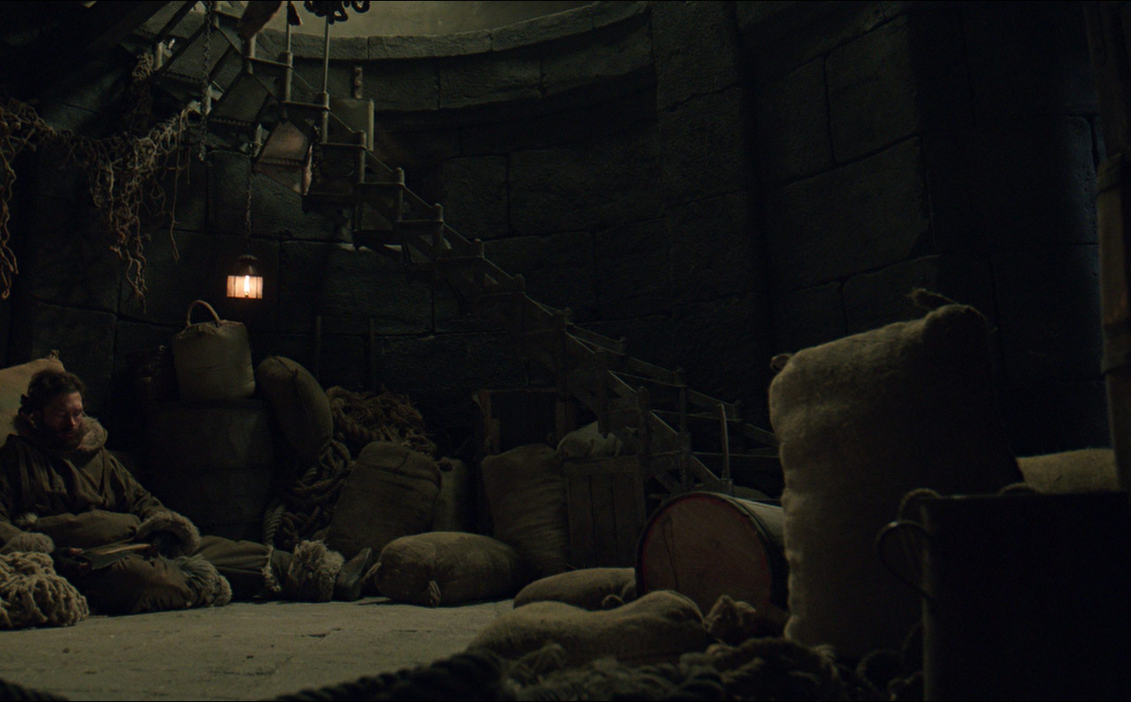 Interior set, ship's hold by lantern light